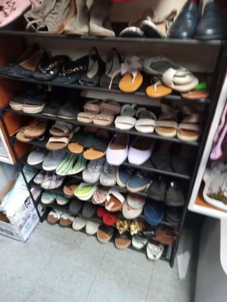 Shelves of donated shoes in many styles.
